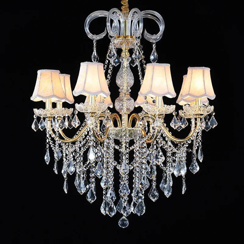 Golden crystal chandelier with fabric lampshades and cascading crystals, perfect for luxury home lighting.