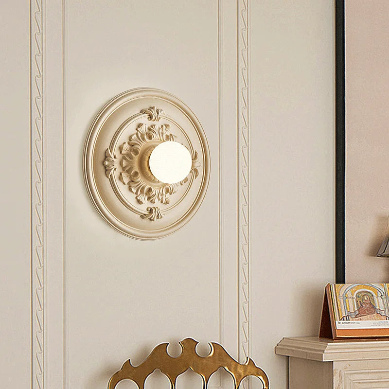LUXELY round bedside wall lamp mounted in a classic bedroom setting, enhancing the wall with soft ambient lighting.