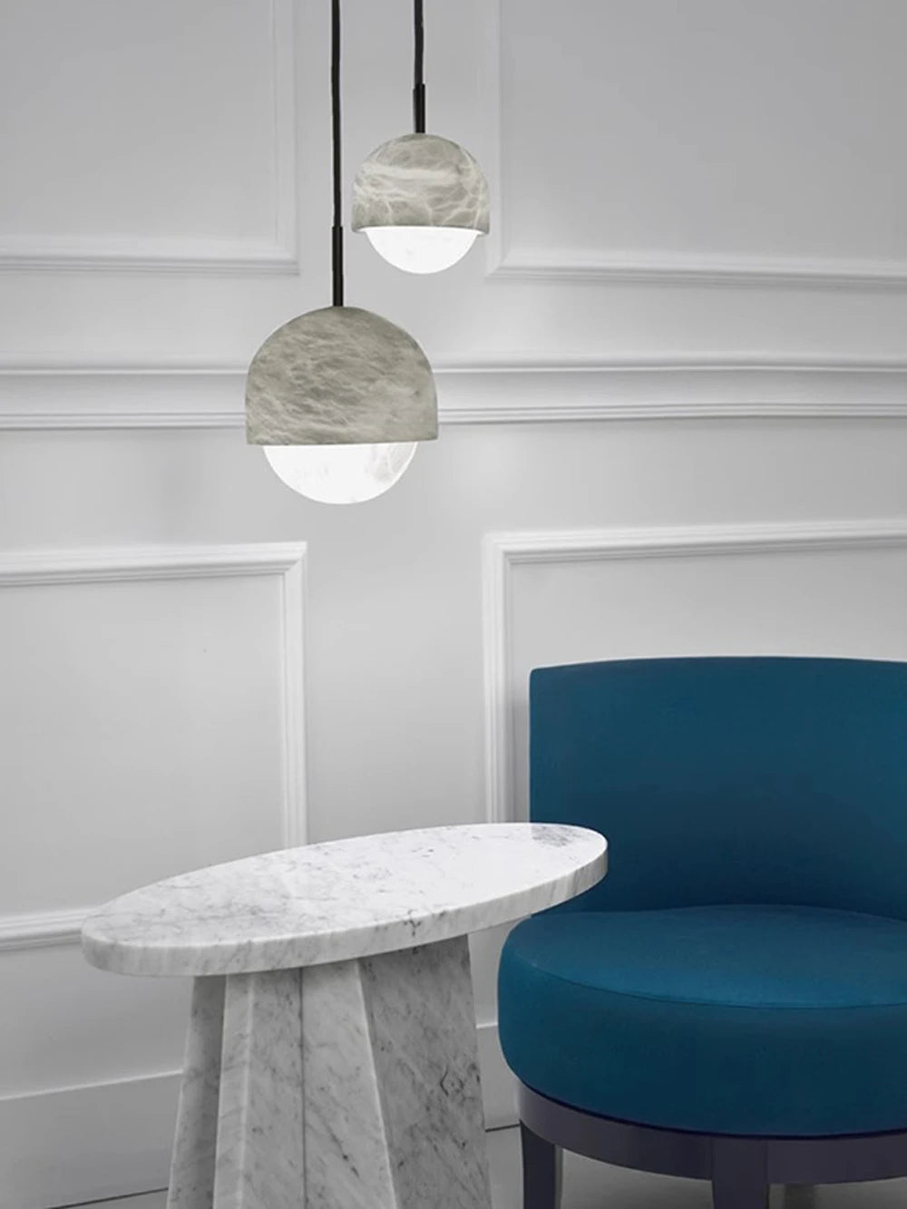 Two dome-shaped marble LED pendant lights above a marble table. Marble LED pendant light – modern ceiling lamp dimmable for luxury decor.