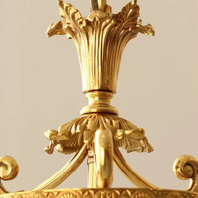 Close-up of ornate copper detailing on retro French chandelier, showcasing intricate craftsmanship and antique finish.