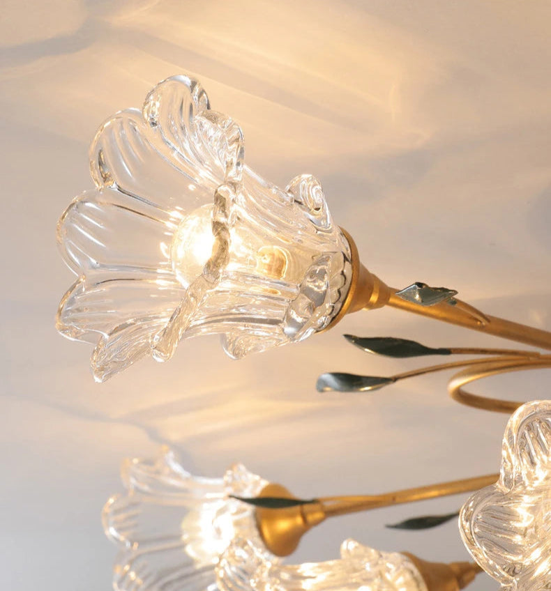 Detailed view of single glass flower lamp head from French Floral Ceiling Light, highlighting clear glass and gold finish.