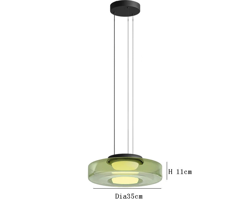 Green glass pendant light with 35cm diameter and 11cm height. LED lighting and adjustable hanging for modern interiors.