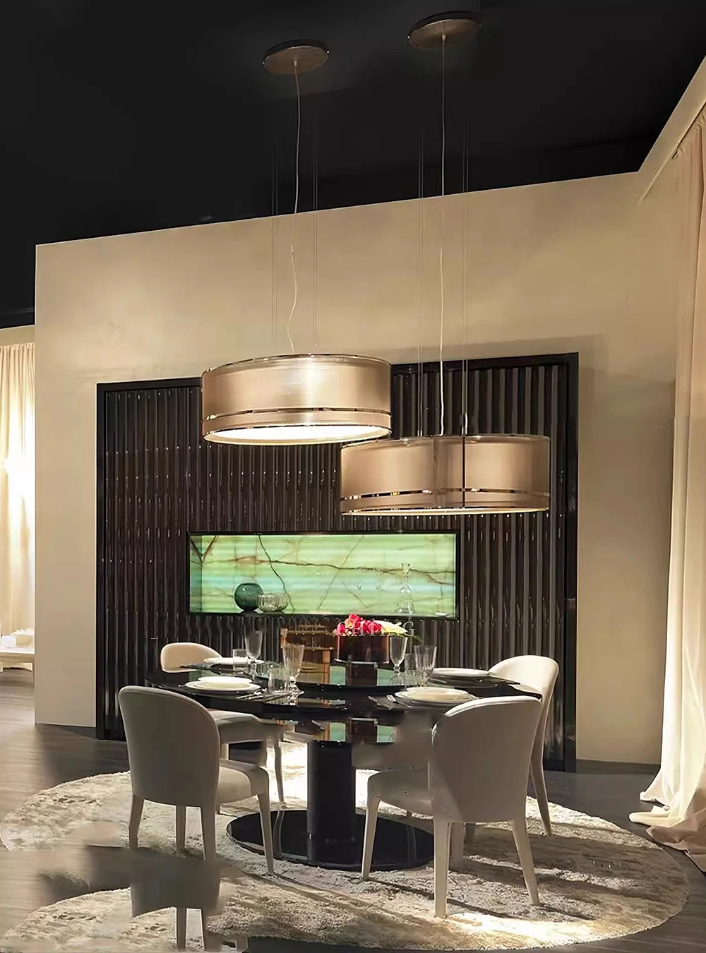 Modern Italian ceiling chandeliers above a round dining table in an upscale dining room with elegant white chairs.