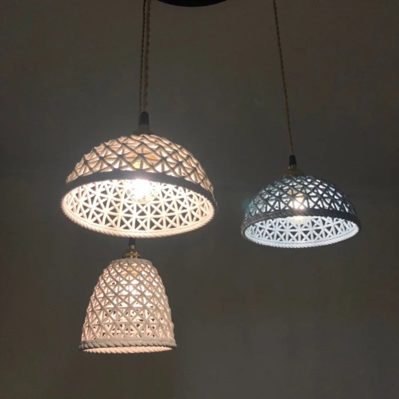 Three LUXELY ceramic Japanese pendant lights illuminated in a dark room, highlighting their textured patterns and soft LED glow.