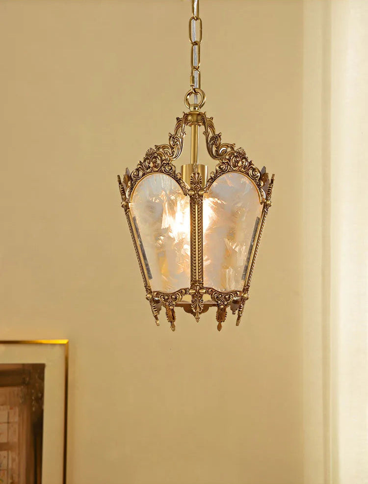Warm LED light glowing through textured glass of a French retro chandelier. Copper finish adds vintage charm to any room.