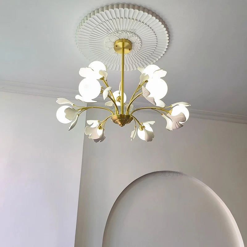 Modern pendant light fixture with soft white illumination and floral design, perfect for contemporary dining or bedroom interiors.