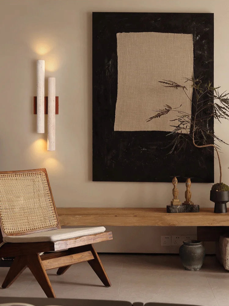 Travertine stone bedroom wall lamp with wood accent mounted beside modern art, adding ambient lighting to a stylish interior.