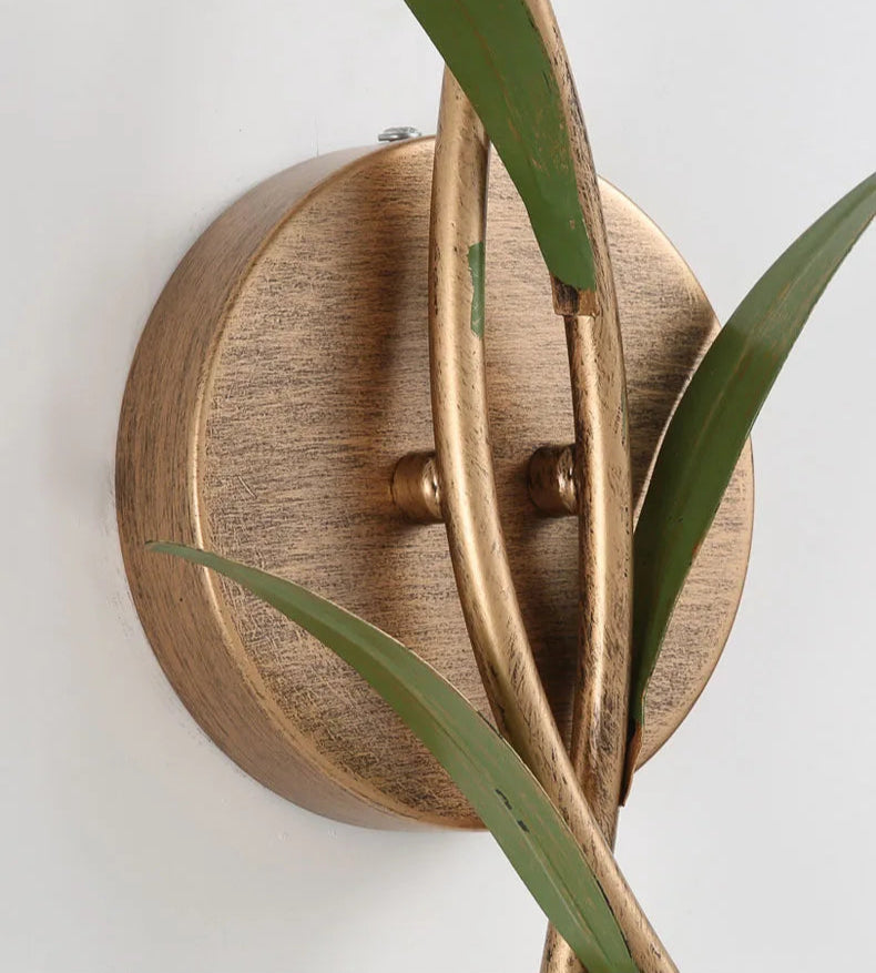 Close-up of French Pastoral Wall Lamp's brass base and intertwined stem design, showcasing vintage craftsmanship and detail.