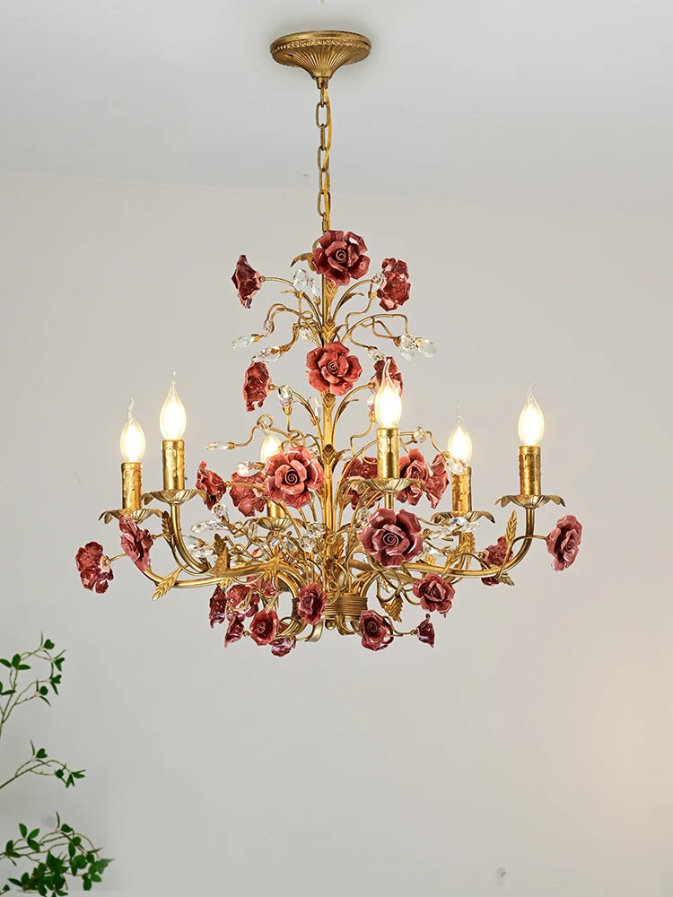 Vintage ceramic chandelier featuring dark pink roses and LED bulbs, a stylish lighting fixture for upscale interiors or dining spaces.