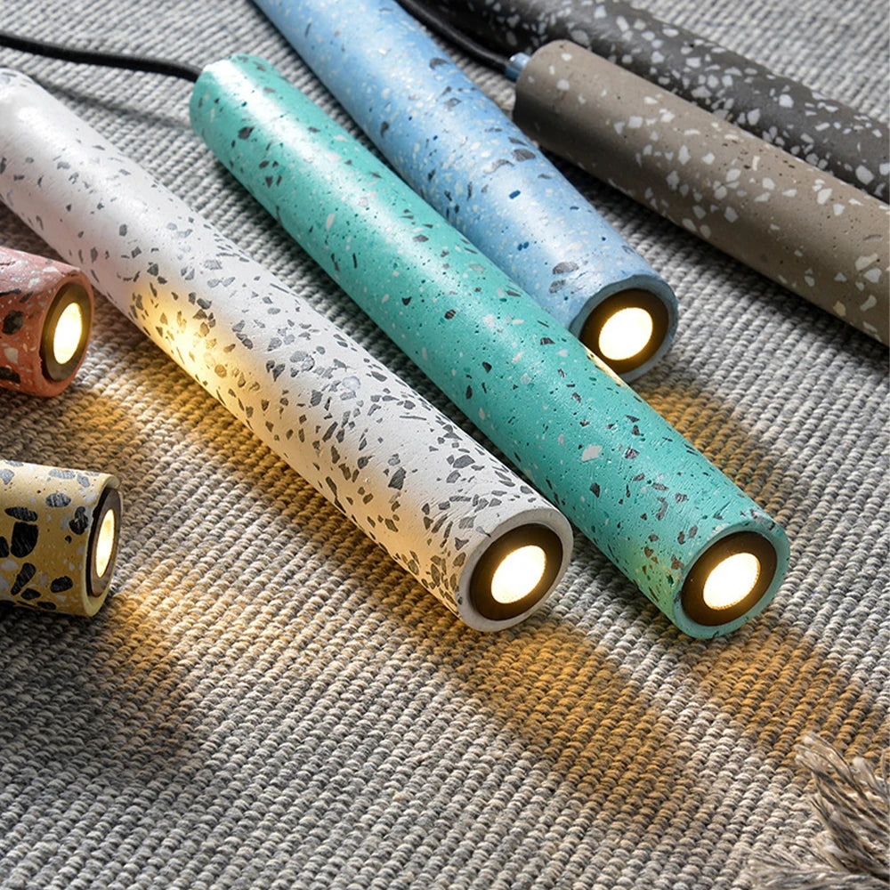 Close-up of colorful LUXELY industrial LED pendant lights with terrazzo texture. Ideal for kitchen, dining, or coffee shop lighting.