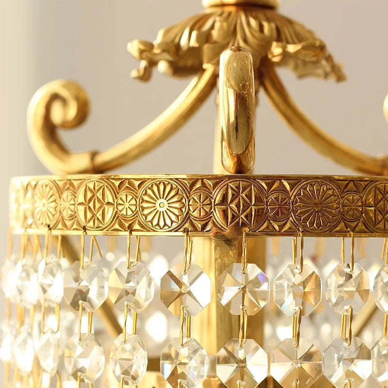 Detailed view of crystal strands and floral copper trim on vintage chandelier, highlighting its elegant design.