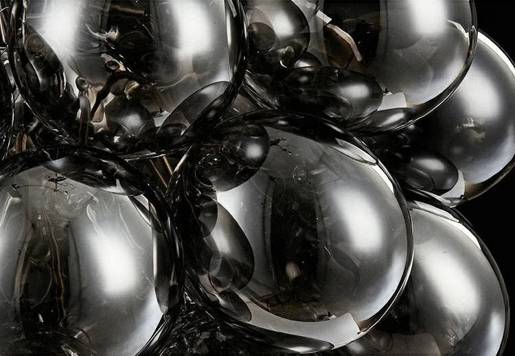 Detailed view of smoked glass bulbs from a modern grape chandelier, highlighting the reflective surface and LED light diffusion.