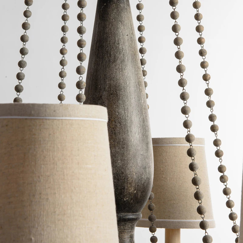 Close-up of Retro Princess Chandelier's wooden beads and fabric lampshades, highlighting its handcrafted vintage detailing.