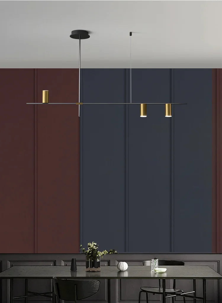 Gold LED spotlight bar ceiling light in a modern dining room with dark walls, perfect for ambient and task lighting.