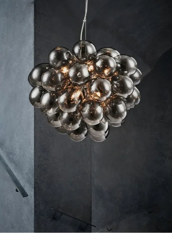 Modern glass chandelier with clustered smoked glass spheres, offering ambient LED lighting for stairwells or modern hallways.