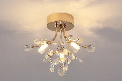 Minimalist crystal chandelier with LED bulbs and gold branches, suitable for contemporary home lighting.