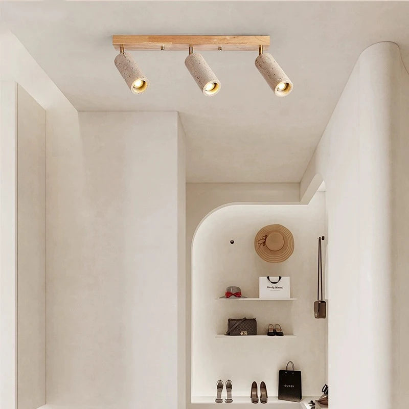 LUXELY 3-head spotlight ceiling lamp in a hallway with curved walls, blending wabi-sabi aesthetics with functional lighting.
