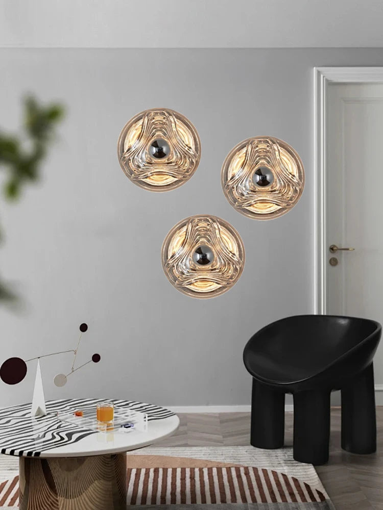 Contemporary living room with trio of round designer glass wall lamps, enhancing modern interior with ambient LED lighting.