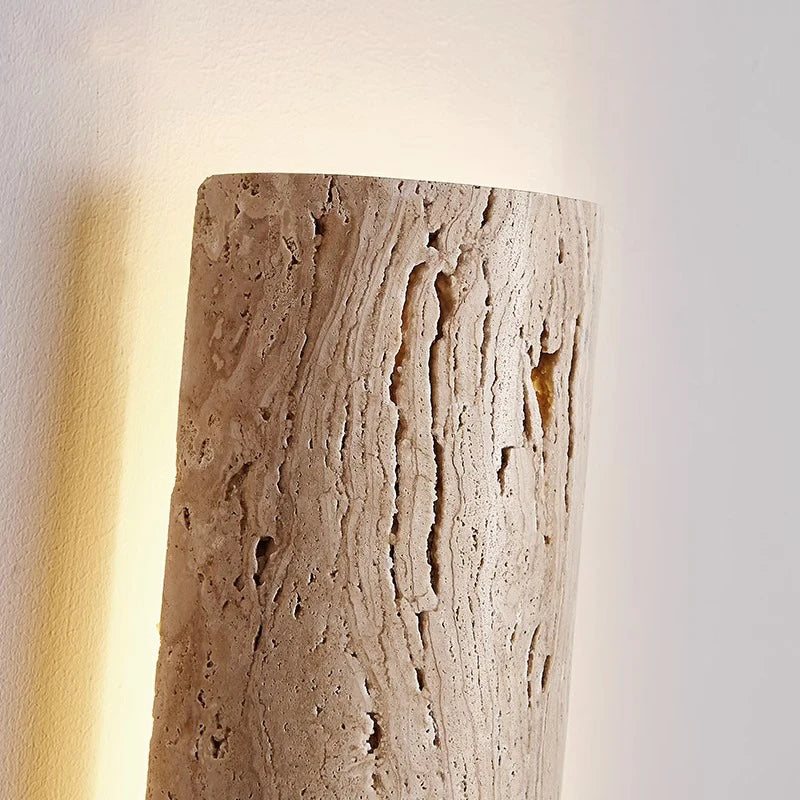 Close-up of IP65 outdoor travertine wall lamp showing detailed stone texture and soft backlighting for elegant wall decor.