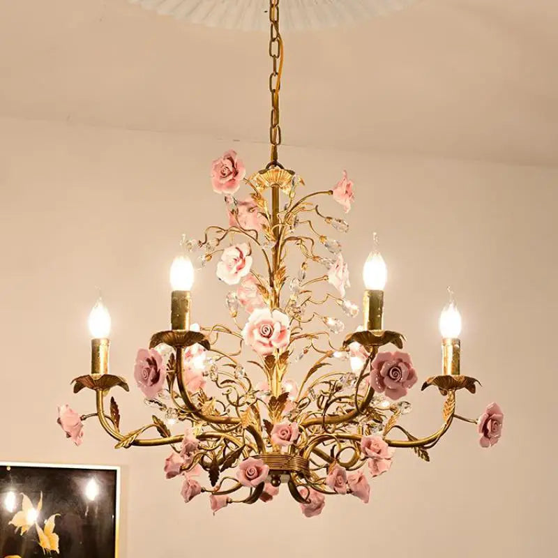 French pink rose chandelier with delicate ceramic blooms and gold detailing, ideal for romantic lighting in cafes or fashion boutiques.