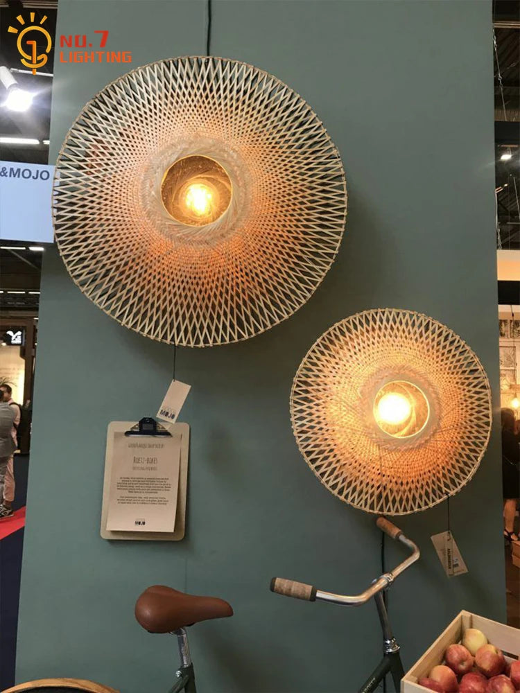 Wabi-sabi round bamboo wall lamps displayed in a lighting showroom, showcasing natural woven texture and warm glow.