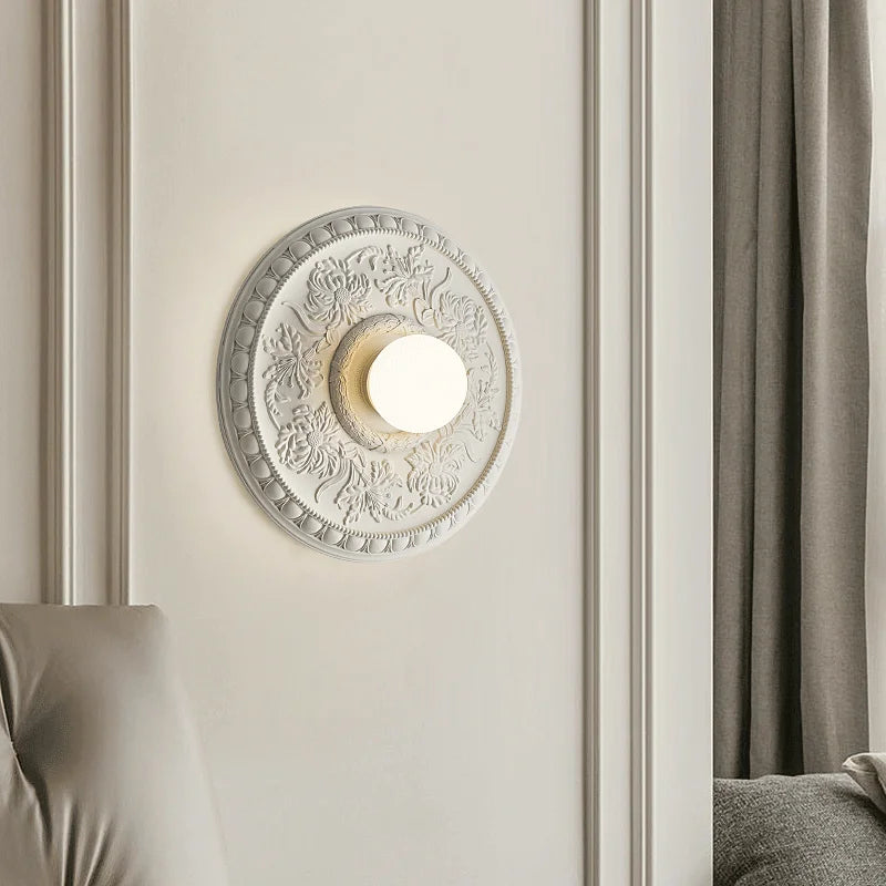 LUXELY wall lamp in white installed beside a bed, offering stylish and functional lighting for bedrooms or hotel suites.
