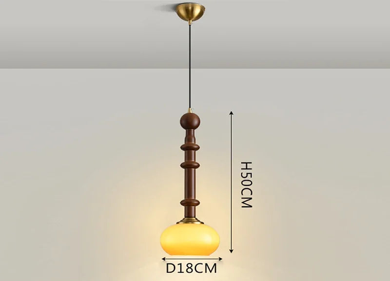 Compact Nordic Pendant Light with amber glass globe and wood stem, ideal for LED lighting in bedrooms or counters.