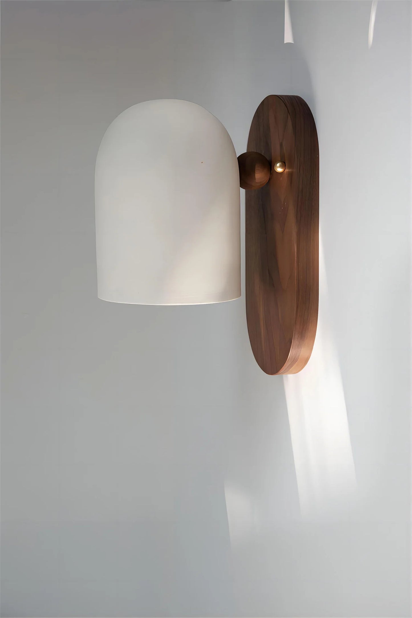 Tall white dome wall sconce with walnut wood base, perfect for modern bedroom or hallway lighting ambiance.
