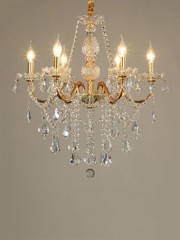 Golden crystal chandelier with five LED candle lights and hanging crystals, ideal for elegant home interiors.