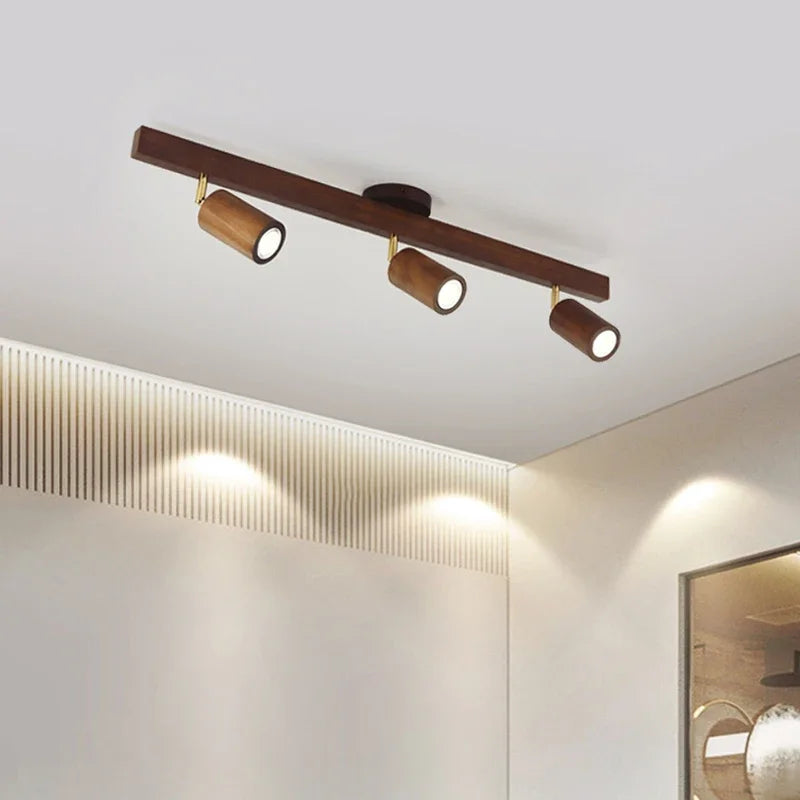 LUXELY wood grain LED spotlight mounted on a bedroom ceiling, offering adjustable lighting for a cozy and modern interior.