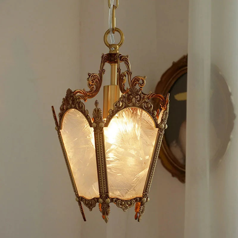 French retro ice flower glass chandelier glowing warmly in a softly lit room. Small copper pendant light for intimate spaces.