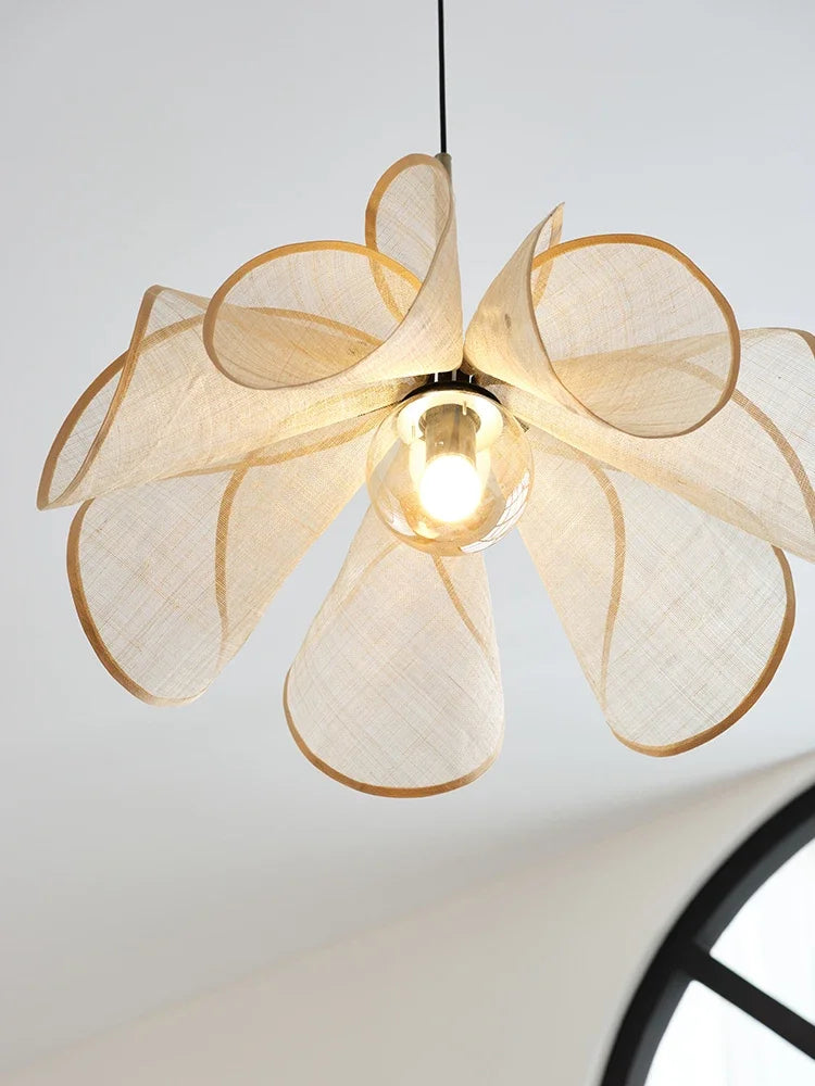 Close-up of bubble glass chandelier with curled translucent fabric petals, showcasing the modern nordic pendant light's sculptural elegance.