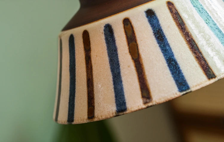 Detail of vertical blue and brown stripes on Porcelain Pendant Light. Durable ceramic with vintage appeal.