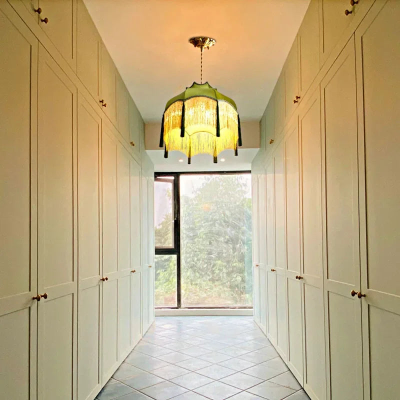 Velvet tassel chandelier - green vintage pendant light installed in a hallway, adding retro elegance to transitional spaces.