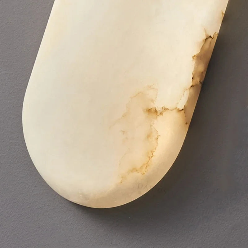 Close-up of real marble texture on LUXELY wall lamp, highlighting natural stone veining and luxury craftsmanship.