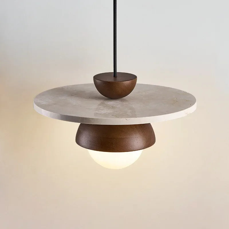 Contemporary walnut wood and stone pendant light with LED bulb, suspended by black cord for modern spaces.