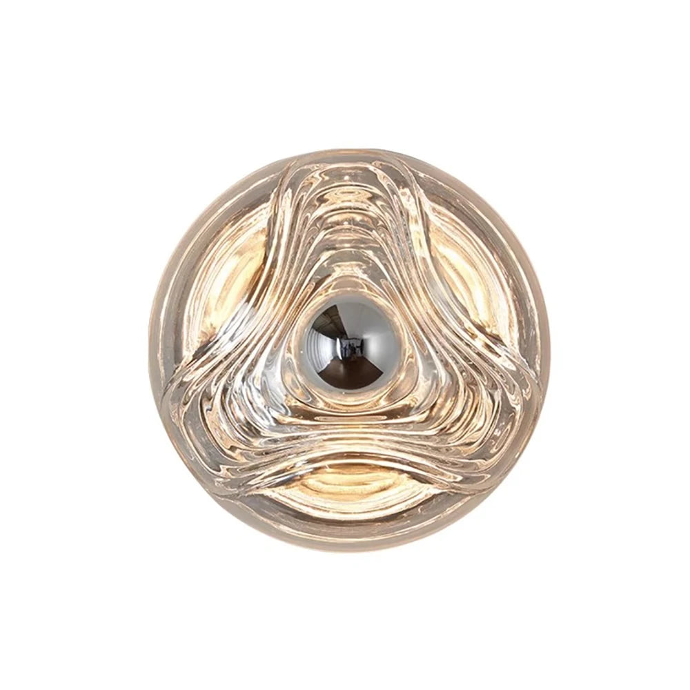 Designer glass wall lamp with round sculpted LED fixture in clear glass, ideal for modern kitchen or restaurant sconce lighting.