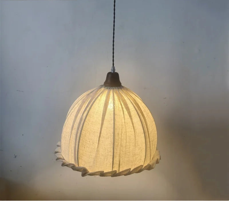 Glowing Nordic pendant lamp with soft fabric shade, ideal for ambient lighting in modern minimalist interiors.