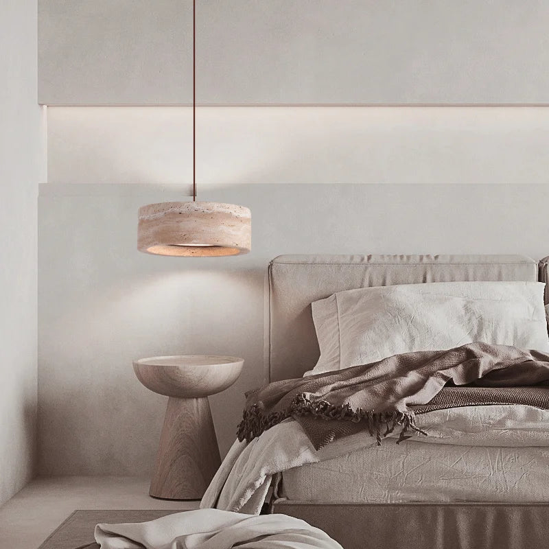 Travertine Retro Pendant Light hanging in a minimalist bedroom, enhancing the serene decor with soft LED illumination and natural stone texture.