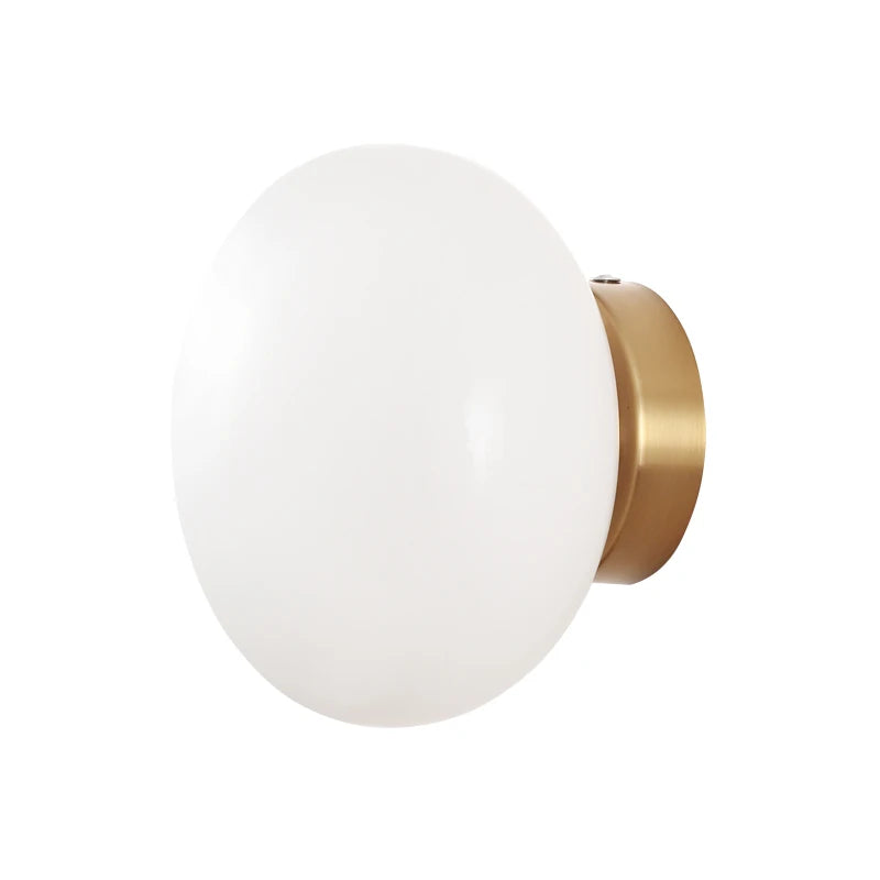 LUXELY ceiling and wall light with white opal glass and brass base, ideal for modern interiors seeking minimalist lighting solutions.