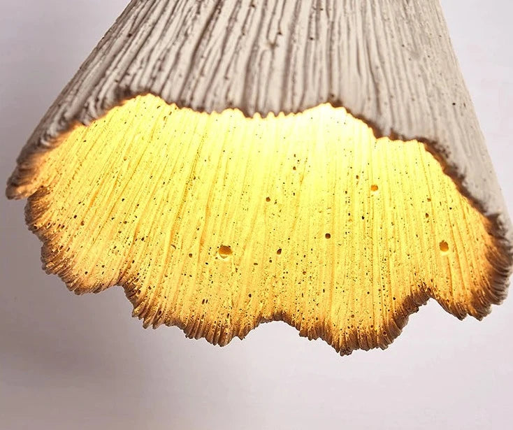 Interior view of travertine pendant light showing glowing textured shade, ideal for creating ambient lighting in modern spaces.