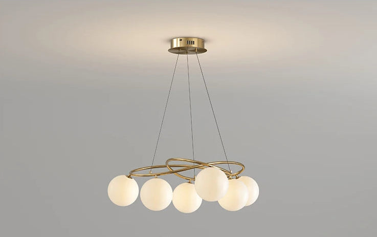 Turned-on LED Chandelier in gold finish with globe bulbs, offering warm light and modern elegance for home interiors.