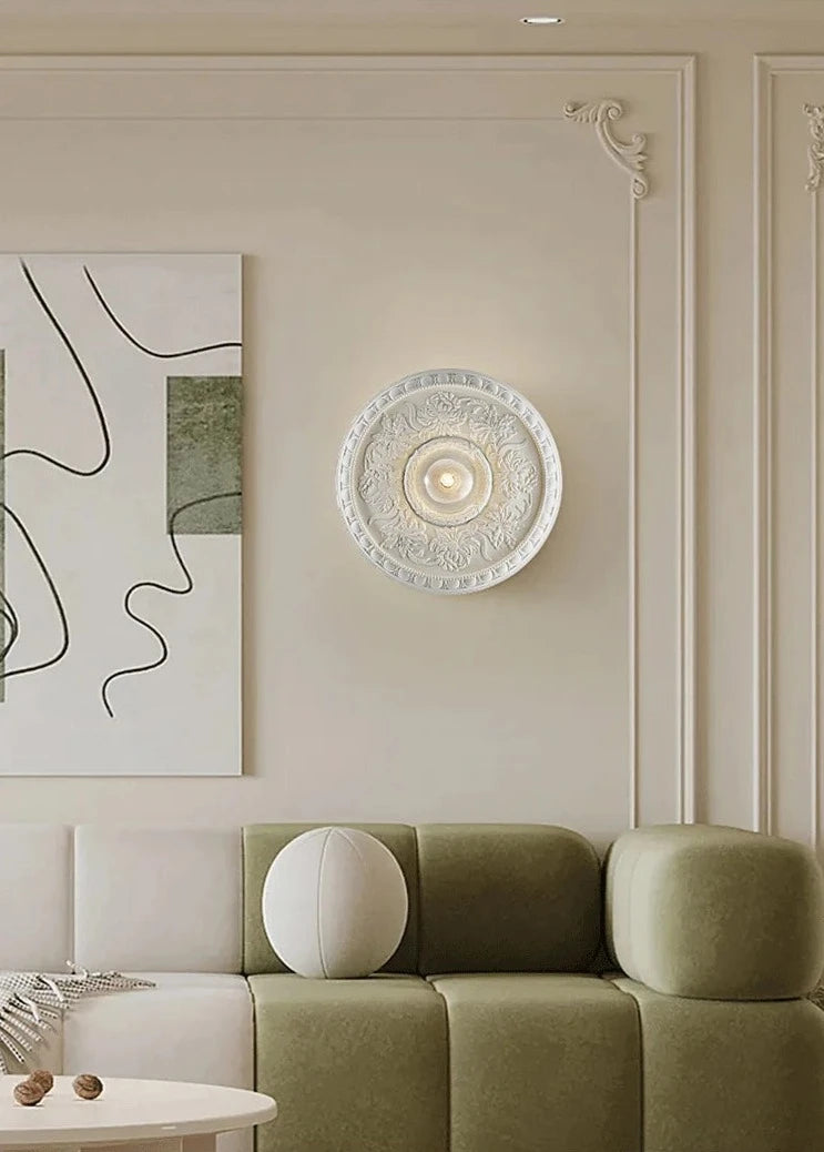 LUXELY retro French wall lamp in white, mounted in a stylish living room with minimalist art and soft tones.