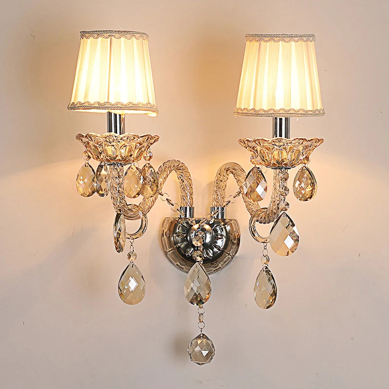 Vintage crystal wall lamp with dual lotus-shaped sconces and pleated fabric shades, ideal for French-style bedroom or corridor lighting.