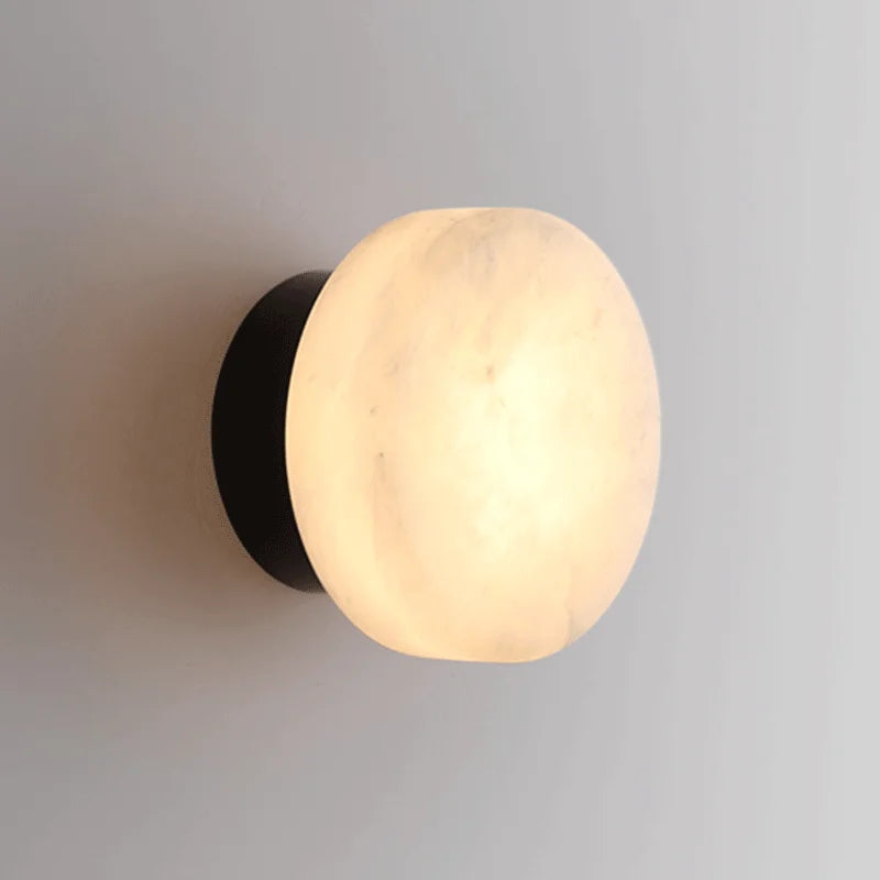Modern LED Marble Wall Lamp with round Spanish marble shade and black base, ideal for living room or corridor lighting.