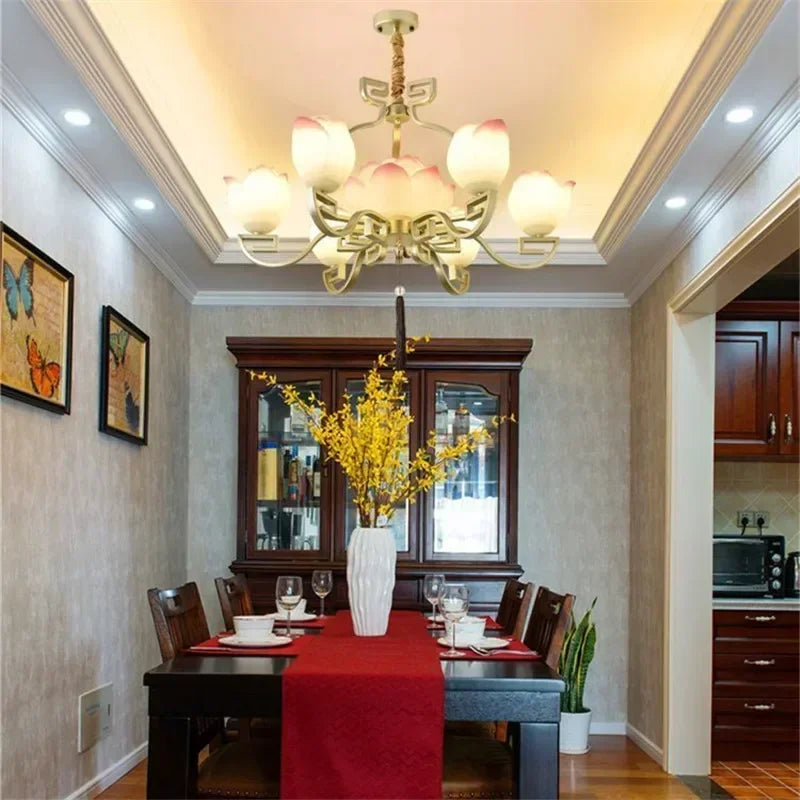 Elegant lotus flower LED pendant light over a dining table, perfect for vintage-inspired dining room settings.