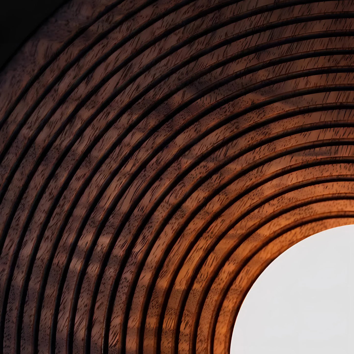 Close-up of concentric carved walnut wood detailing on the LUXELY ceiling light, highlighting craftsmanship and texture.