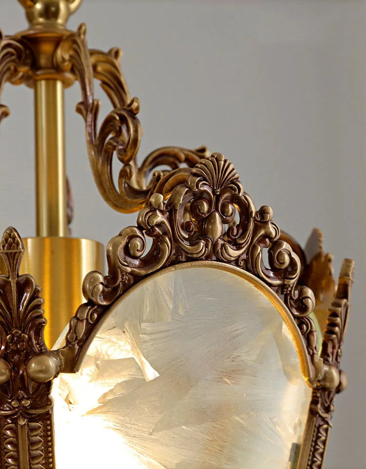 Detailed view of copper scrollwork on French retro chandelier. Ice flower glass enhances vintage elegance and light diffusion.
