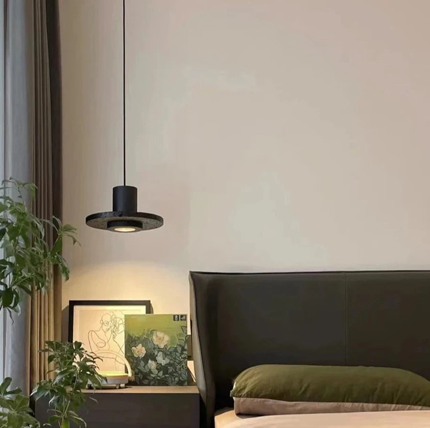 LUXELY industrial pendant light hanging beside a bed, perfect for creating a cozy and stylish bedroom atmosphere.