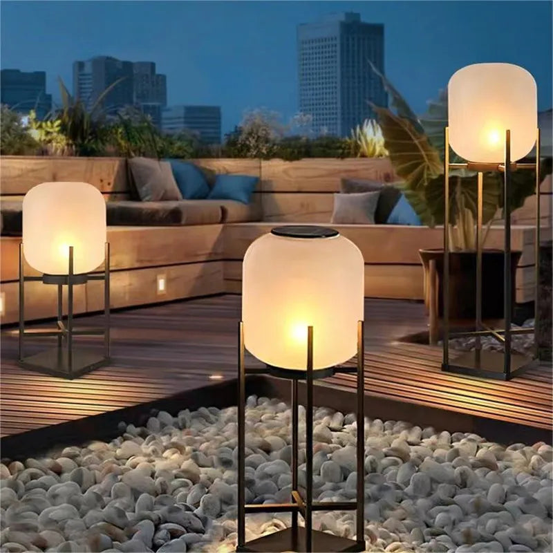 Set of LUXELY solar powered garden lights illuminating a modern villa deck, perfect for outdoor pathway and backyard ambiance.
